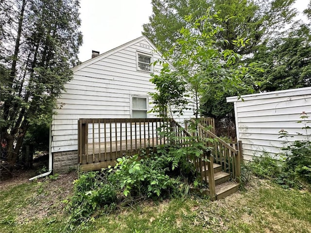 view of side of home featuring a wooden deck