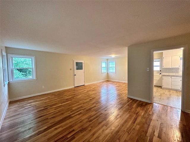 spare room featuring wood finished floors and baseboards