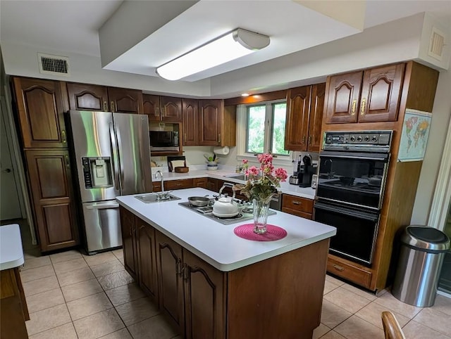 5441 Thomas Rd, Fairview, PA 16415 - kitchen with stainless steel appliances, a sink, light tile patterned floors, and light countertops
