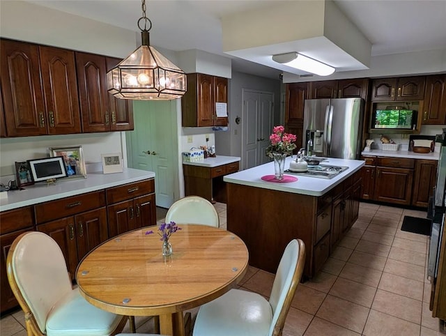 5441 Thomas Rd, Fairview, PA 16415 - kitchen featuring stainless steel fridge with ice dispenser, light tile patterned flooring, stovetop with downdraft, light countertops, and a center island