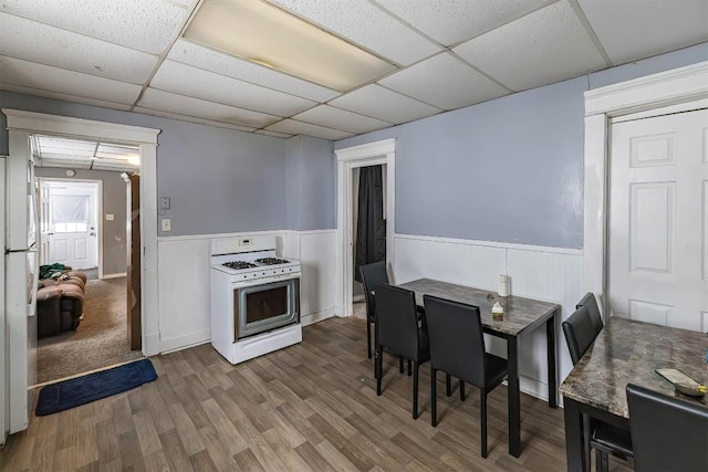 946 W 17th St, Erie, PA 16502 - dining area with a paneled ceiling, wood finished floors, and a wainscoted wall