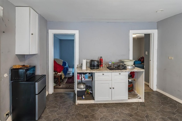 946 W 17th St, Erie, PA 16502 - kitchen featuring black microwave, open shelves, white cabinets, and light stone countertops