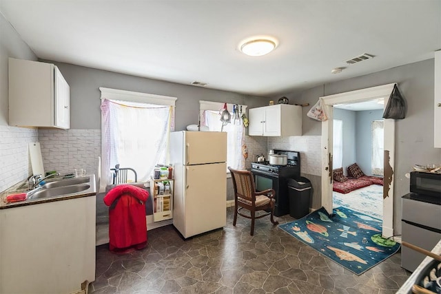 946 W 17th St, Erie, PA 16502 - kitchen featuring black appliances, white cabinetry, and backsplash