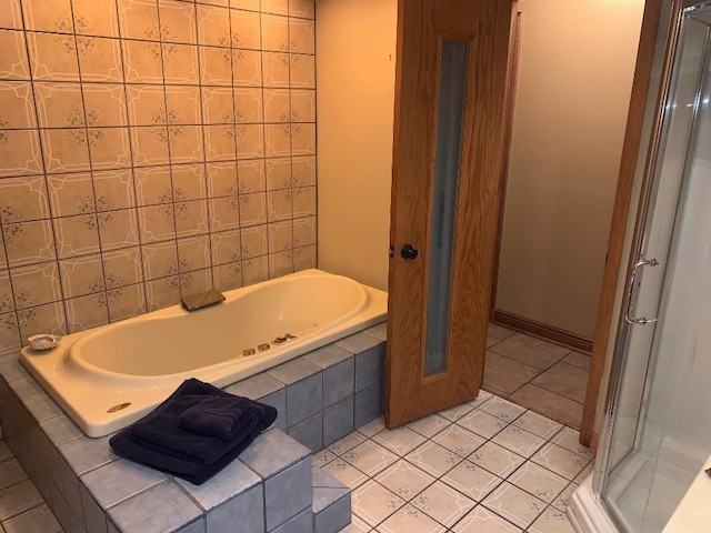 bathroom with tile patterned flooring and independent shower and bath