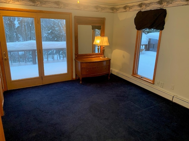 spare room with dark carpet and plenty of natural light