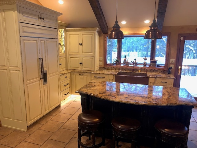 kitchen with a center island, a wealth of natural light, sink, and beamed ceiling