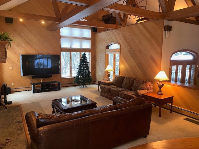 living room with wood walls, high vaulted ceiling, a baseboard heating unit, carpet flooring, and beam ceiling