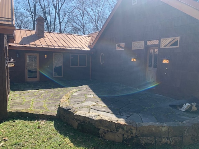 21700 Springs Rd, Meadville, PA 16335 - rear view of house with a patio area, a chimney, a standing seam roof, and metal roof