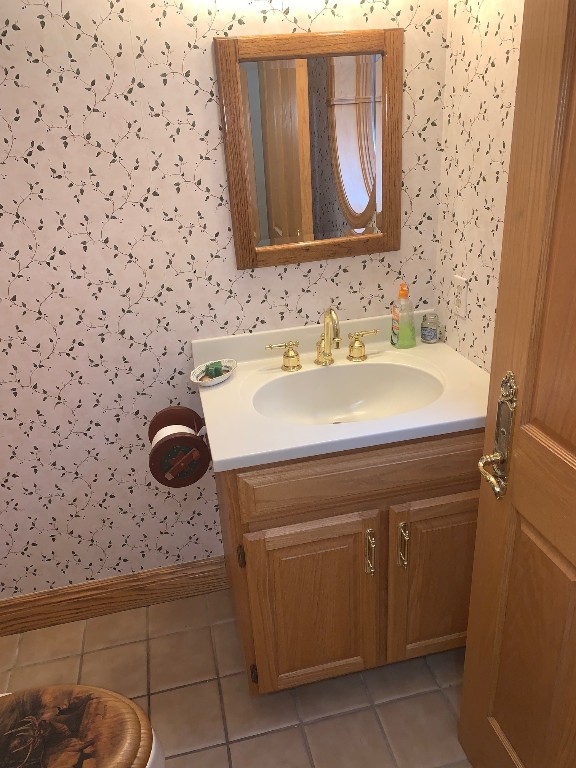 21700 Springs Rd, Meadville, PA 16335 - bathroom featuring wallpapered walls, baseboards, tile patterned floors, and vanity