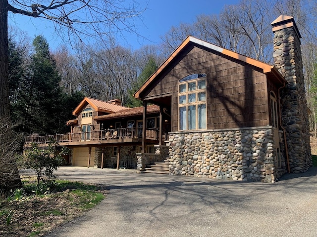 21700 Springs Rd, Meadville, PA 16335 - chalet / cabin with stone siding, driveway, a chimney, and a garage