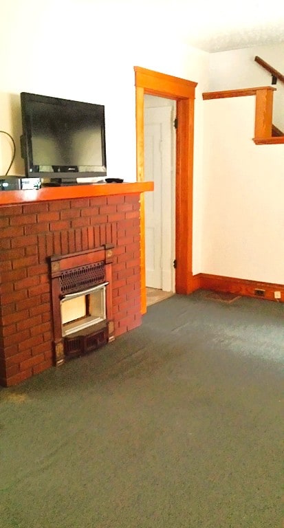 362 Randolph St, Meadville, PA 16335 - carpeted living area with a brick fireplace and baseboards