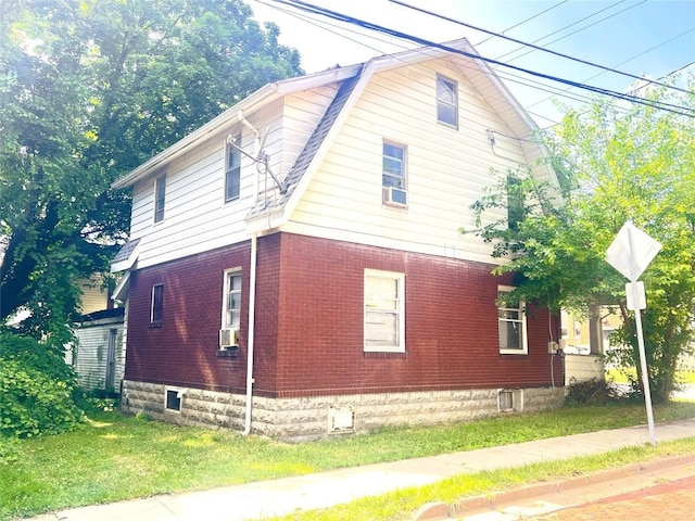 362 Randolph St, Meadville, PA 16335 - view of property exterior featuring brick siding, a lawn, and cooling unit