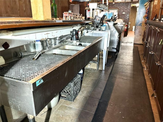 kitchen featuring brick wall