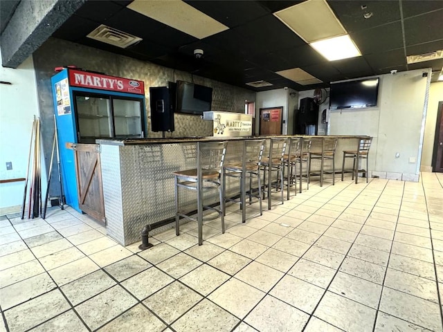 bar featuring a paneled ceiling