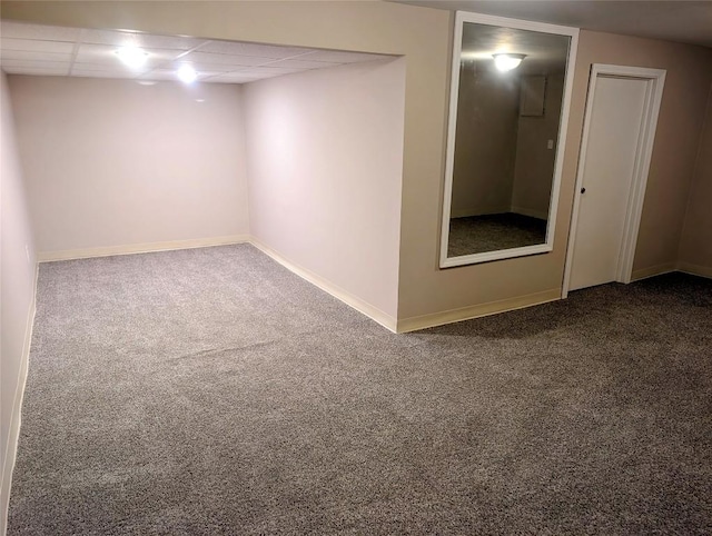 basement featuring carpet and a drop ceiling