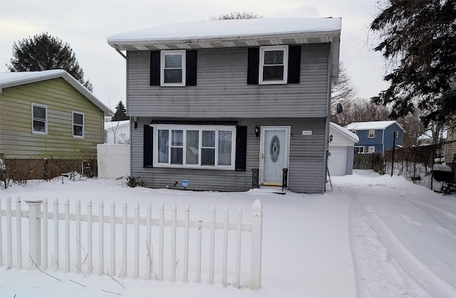 view of front facade featuring a garage and fence