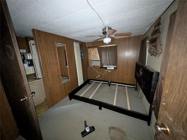 12838 Reed Ave, Conneaut Lake, PA 16316 - unfurnished bedroom featuring wooden walls, cooling unit, carpet floors, and a ceiling fan