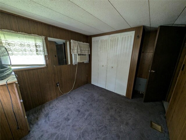 12838 Reed Ave, Conneaut Lake, PA 16316 - unfurnished bedroom featuring wood walls, carpet, cooling unit, and a closet