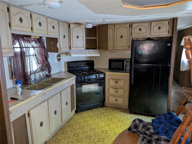 12838 Reed Ave, Conneaut Lake, PA 16316 - kitchen with black appliances, a sink, light countertops, and cream cabinetry