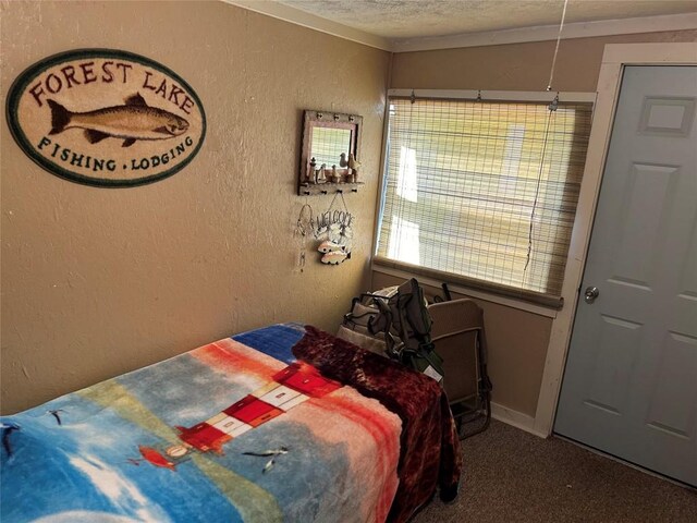 carpeted bedroom featuring a textured ceiling