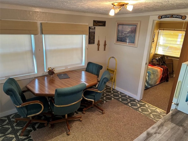 dining space featuring carpet floors and a textured ceiling