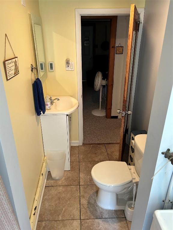 bathroom with tile patterned flooring, vanity, and toilet