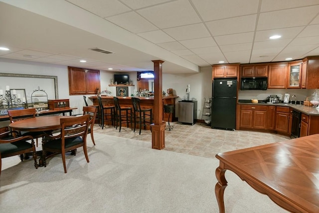 carpeted dining space with sink