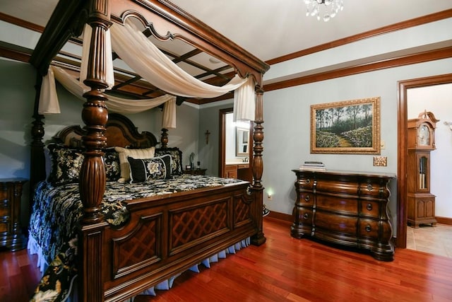 bedroom with ornamental molding and hardwood / wood-style flooring