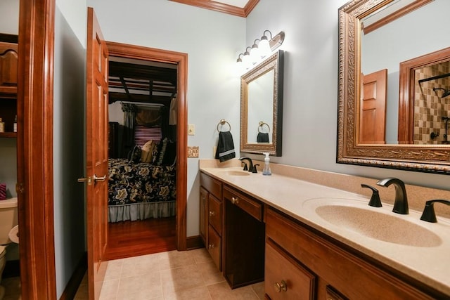 bathroom featuring toilet, ornamental molding, tile patterned floors, and vanity