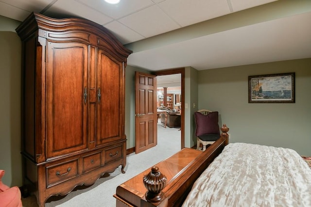 carpeted bedroom with a paneled ceiling