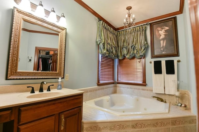 bathroom featuring a relaxing tiled tub, ornamental molding, an inviting chandelier, and vanity