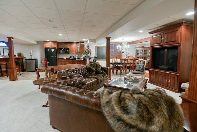 living area with light carpet, decorative columns, a paneled ceiling, and recessed lighting