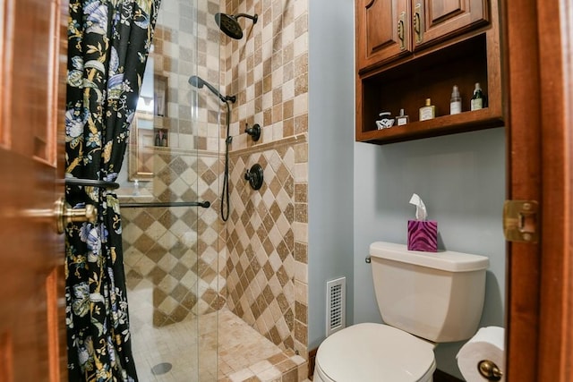 bathroom featuring toilet and an enclosed shower