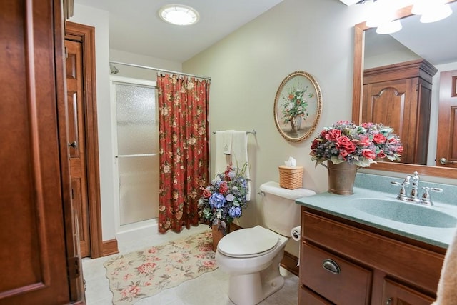 bathroom featuring toilet, vanity, and walk in shower