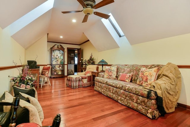 living room with lofted ceiling, hardwood / wood-style floors, ceiling fan, and ornamental molding