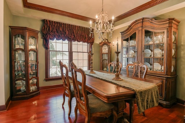 dining room featuring an inviting chandelier, ornamental molding, and dark hardwood / wood-style flooring