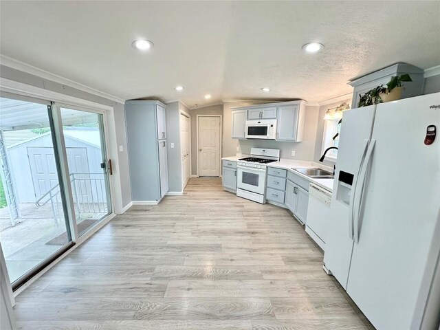 10644 W Main Rd Unit 45, North East, PA 16428 - kitchen with white appliances, ornamental molding, light wood-style floors, recessed lighting, and light countertops