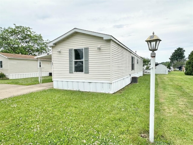 10644 W Main Rd Unit 45, North East, PA 16428 - view of side of property with a lawn and a cooling unit