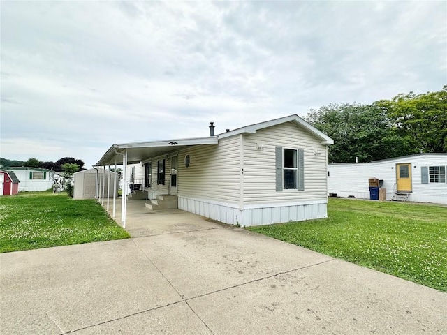 10644 W Main Rd Unit 45, North East, PA 16428 - manufactured / mobile home with an attached carport, a storage unit, a front lawn, and driveway