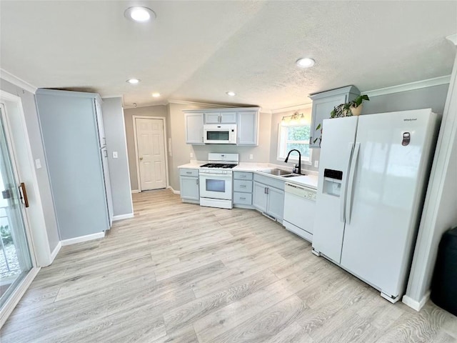 10644 W Main Rd Unit 45, North East, PA 16428 - kitchen featuring white appliances, crown molding, light wood-style floors, light countertops, and vaulted ceiling