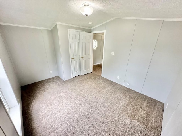 10644 W Main Rd Unit 45, North East, PA 16428 - unfurnished bedroom with crown molding, carpet, a textured ceiling, a closet, and lofted ceiling