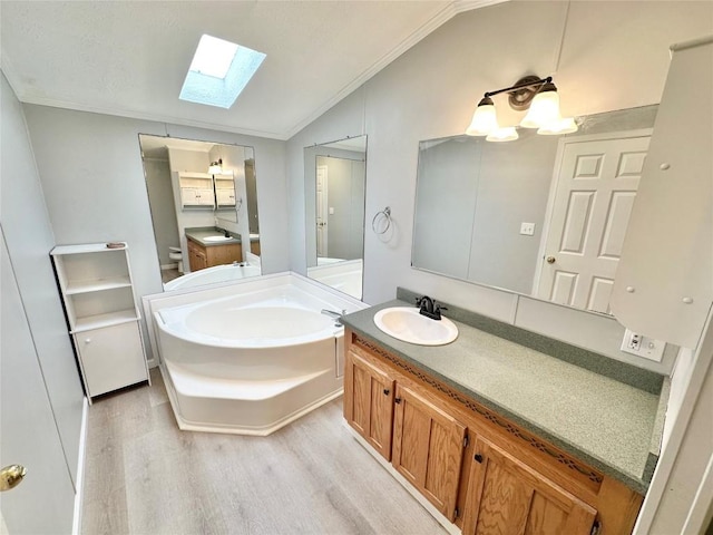 10644 W Main Rd Unit 45, North East, PA 16428 - bathroom featuring vaulted ceiling, wood finished floors, ornamental molding, a skylight, and a bath