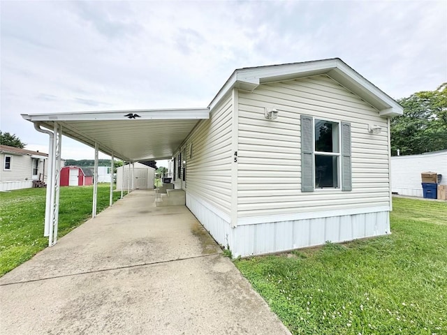 10644 W Main Rd Unit 45, North East, PA 16428 - view of front of property featuring a storage shed, a front yard, driveway, and an attached carport