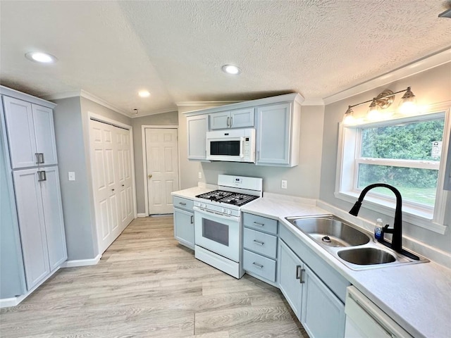 10644 W Main Rd Unit 45, North East, PA 16428 - kitchen with white appliances, ornamental molding, recessed lighting, light countertops, and light wood finished floors