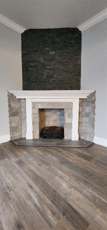 details with wood-type flooring, crown molding, and a fireplace