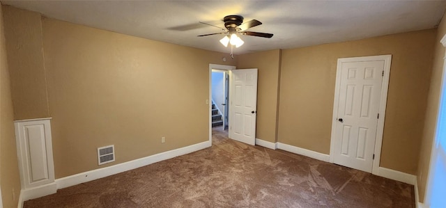 unfurnished bedroom with ceiling fan and carpet