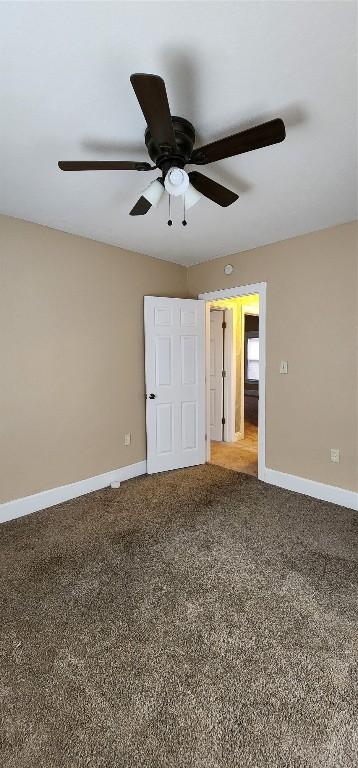 unfurnished bedroom with ceiling fan and carpet