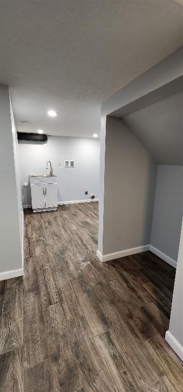 laundry area featuring dark hardwood / wood-style flooring and sink