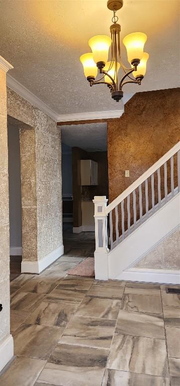 interior space featuring crown molding and a chandelier