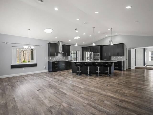 11350 State Highway 618, Conneaut Lake, PA 16316 - kitchen with appliances with stainless steel finishes, vaulted ceiling, wall chimney range hood, a breakfast bar area, and plenty of natural light